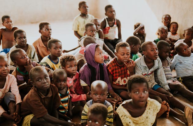 African children sitting on the floor at school