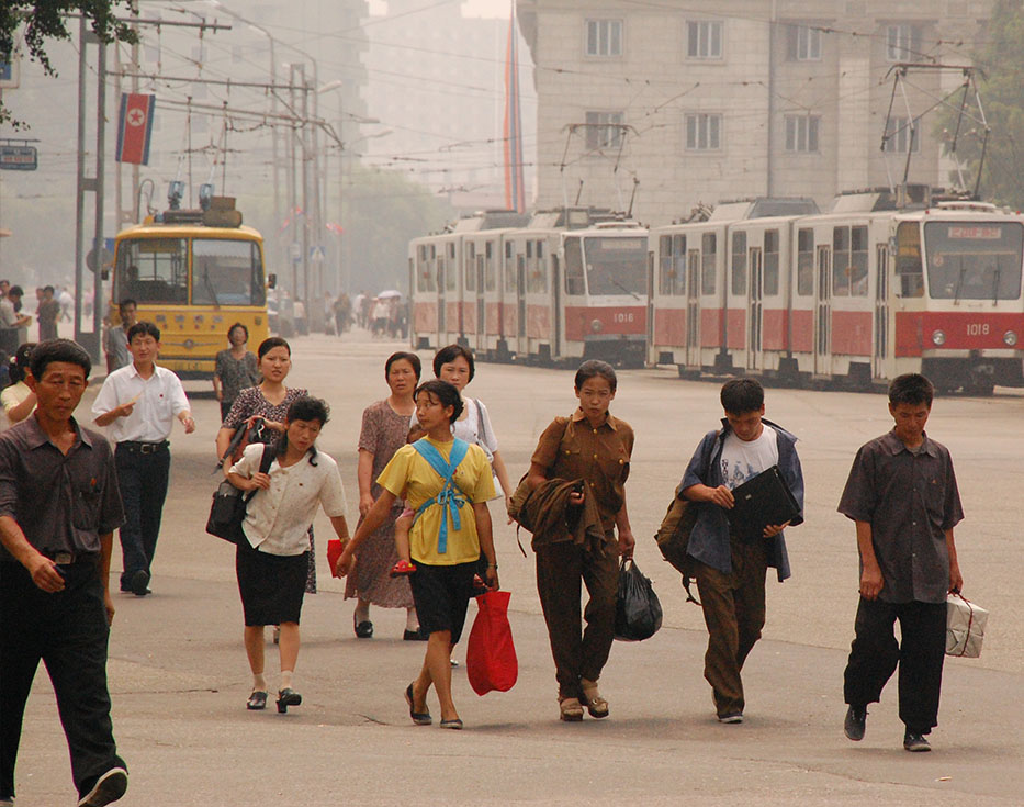 North Koreans walk down the street carrying their belongings