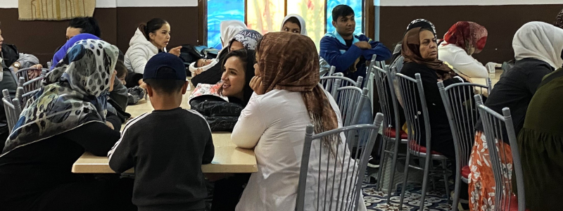 Turkish Christians sit a tables talking among one another