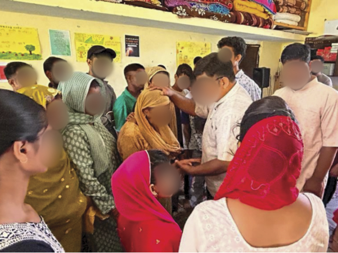 Christian missionary in South Asia praying for others at a local school