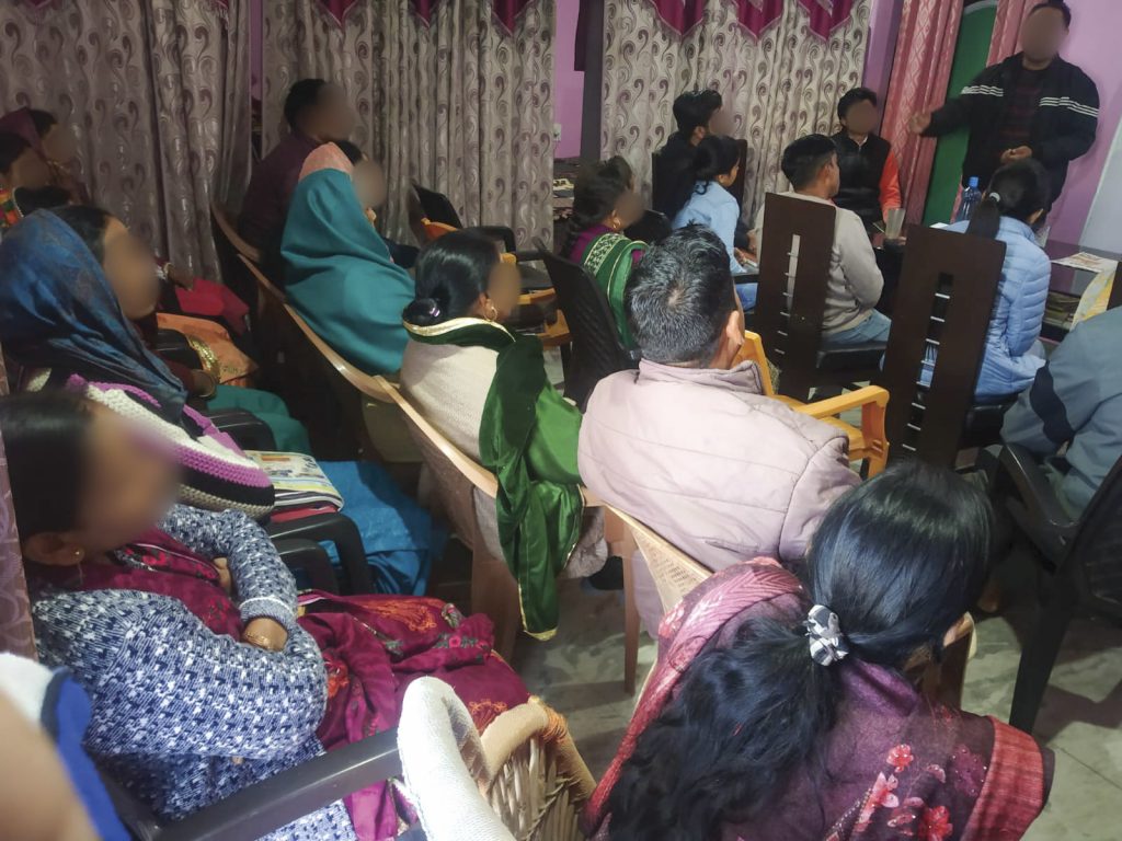 Christians in South Asia gathered together for church in a small room sitting in rows of plastic chairs