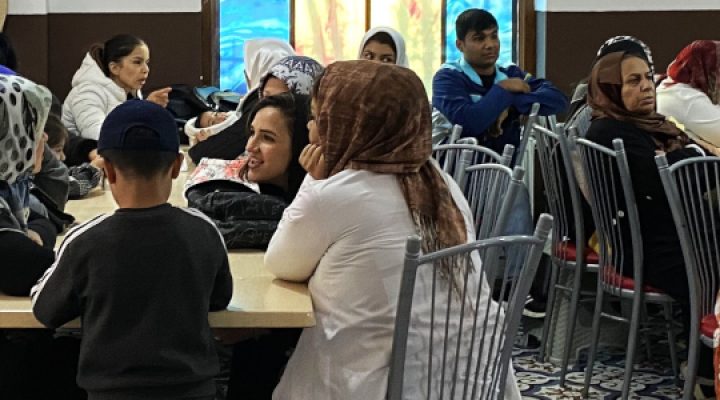 Turkish Christians sit a tables talking among one another